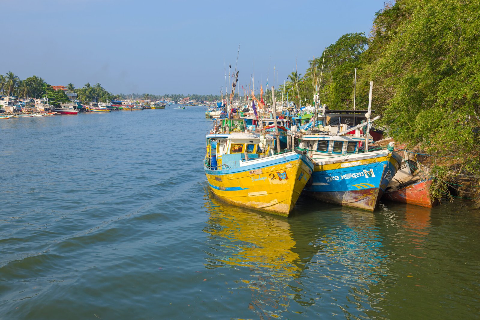NEGOMBO, SRI LANKA - FEBRUARY 03, 2020: Fishing boats in the city lagoon on a sunny day