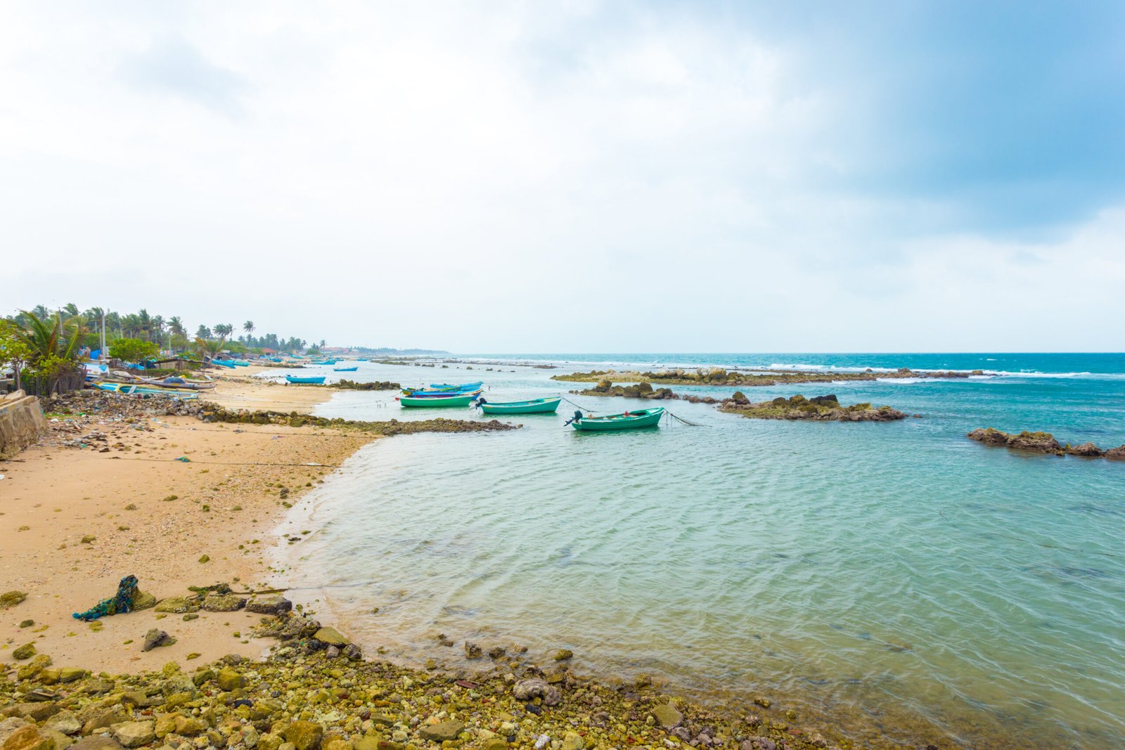 Fishing boats anchored outside a fishermen village in Point Pedro on a stormy day along the northern coast of Jaffna, Sri Lanka. Horizontal