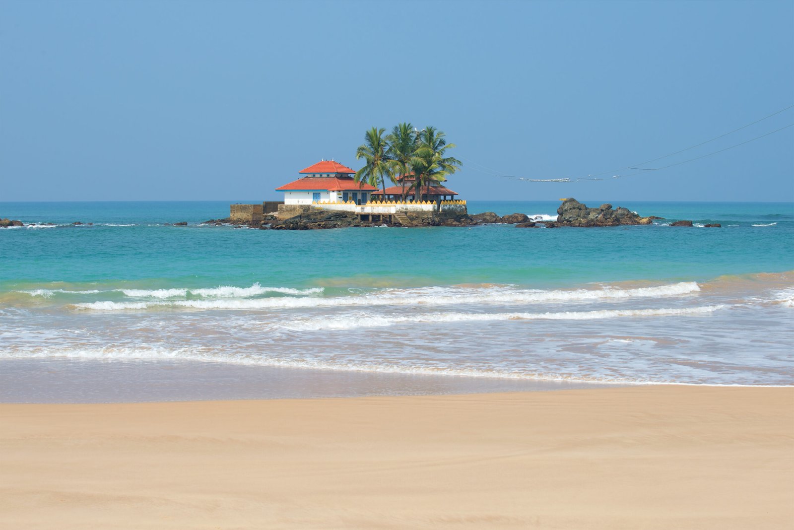 Buddhist temple, Seenigama Muhudu Viharaya, coral reef in the Indian ocean. The neighborhood of Hikkaduwa, Sri Lanka